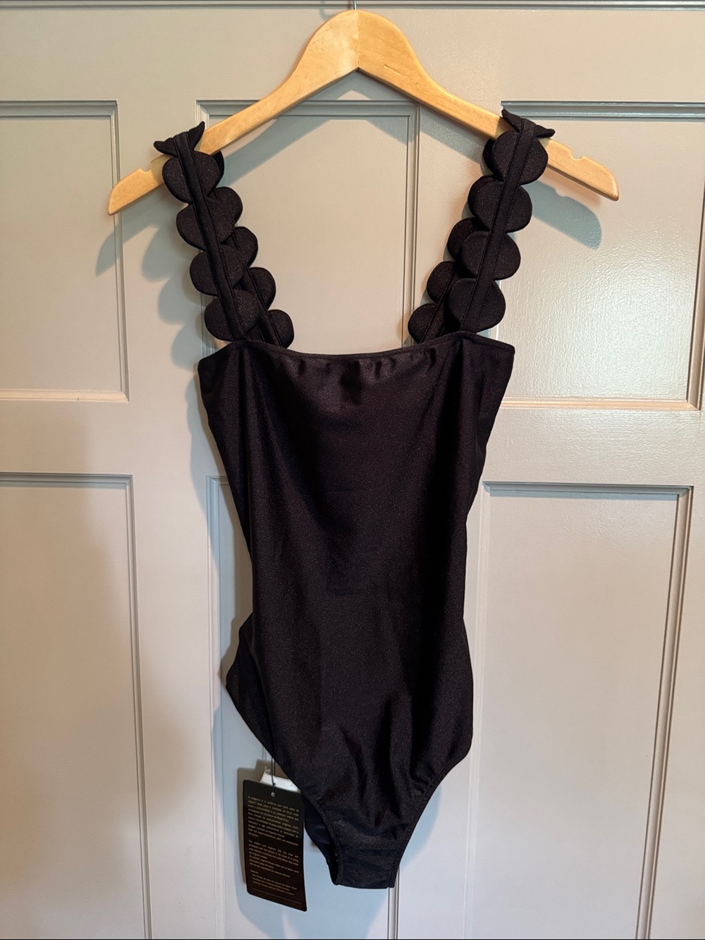 Black One-Piece Swimsuit with Scalloped Straps.